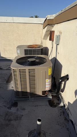 Two rooftop AC condenser units installed