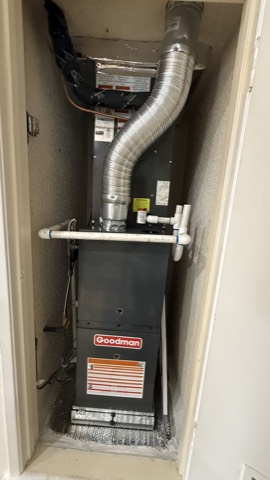 Goodman gas furnace in closet with flue