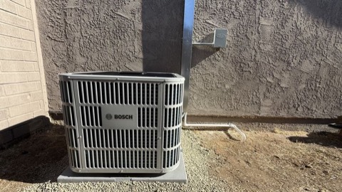 Bosch AC condenser by stucco wall