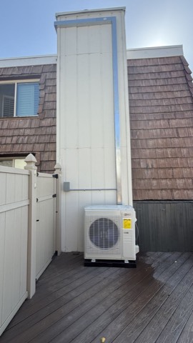 Mini-split condenser on deck with line cover