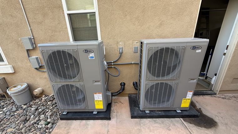 Two AC Pro condenser units side by side