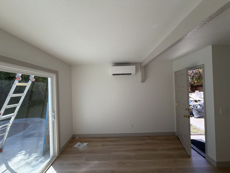 Wall-mounted mini-split head in room
