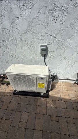 Mini-split outdoor condenser on paver patio