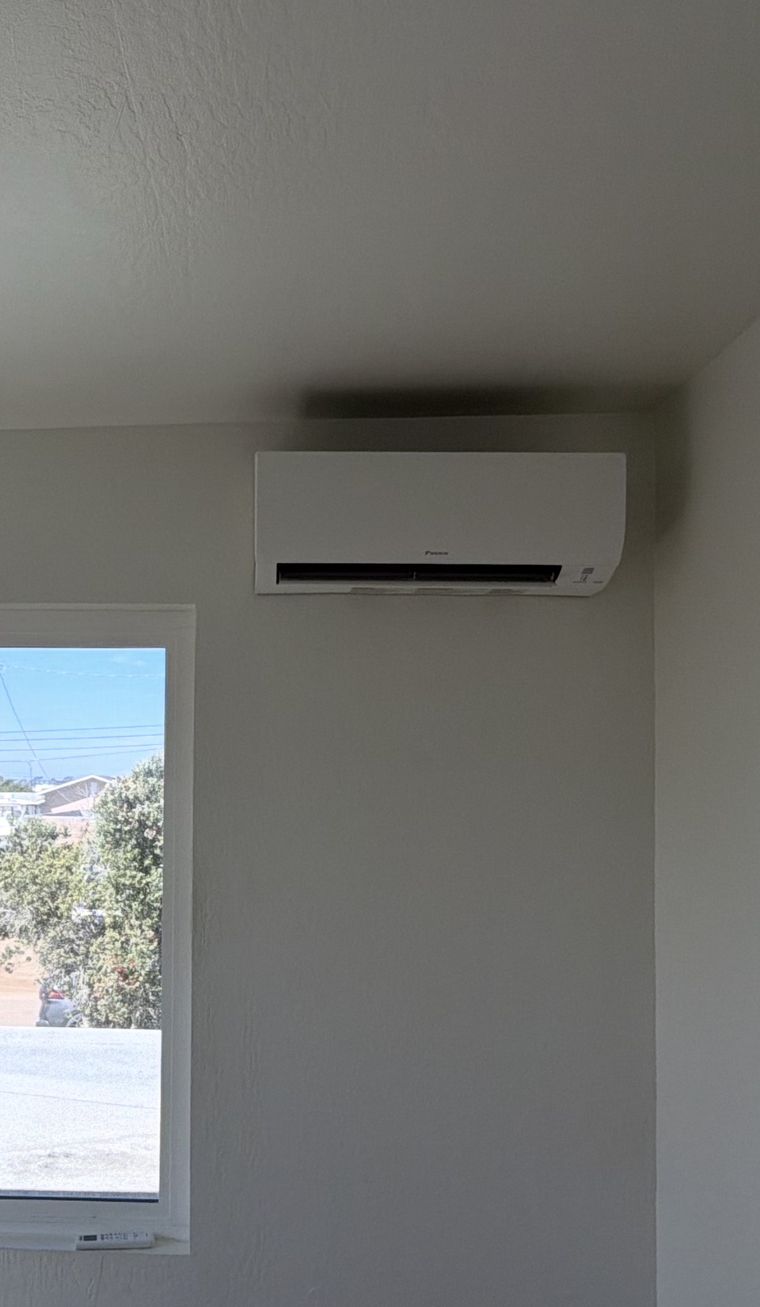 Daikin mini-split head near bright window