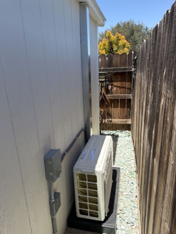 Mini-split outdoor condenser beside house